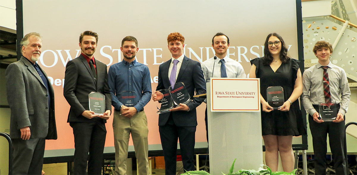 Department of Aersospace Engineering senior honorees on stage with chair Alric Rothmayer