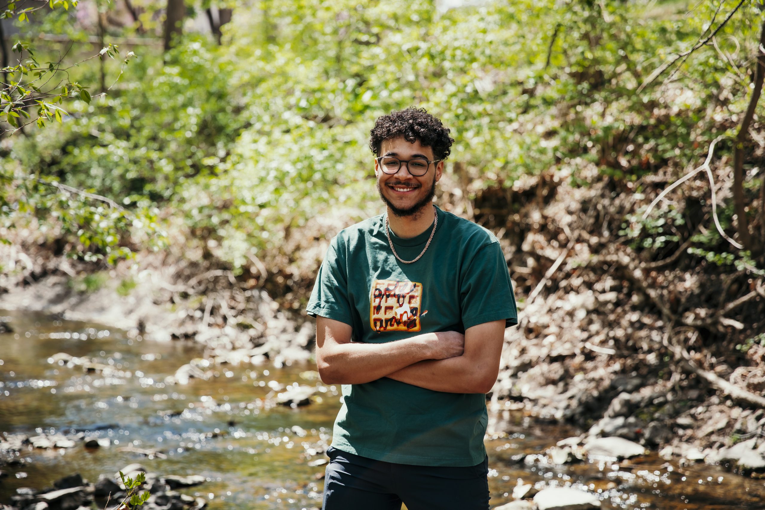 Nikolai Stevens standing next to a creek 