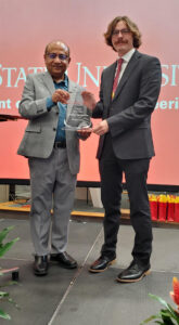 Bradenn Droegmiller with award and Partha Sarkar
