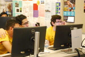 Iowa State student team work together on computer in programming competition