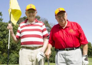 Wallace Sanders and Jack Cleasby playing golf together