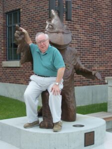 Wallace Sanders with Cy statue