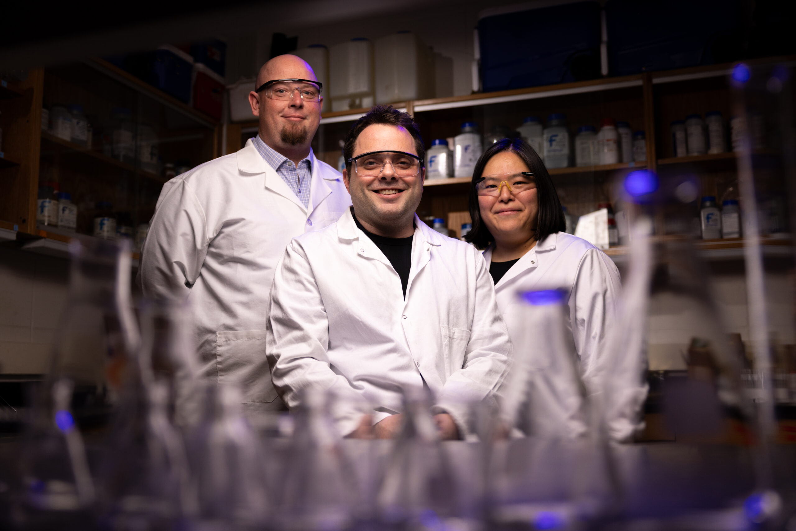 Team of three scientists in lab