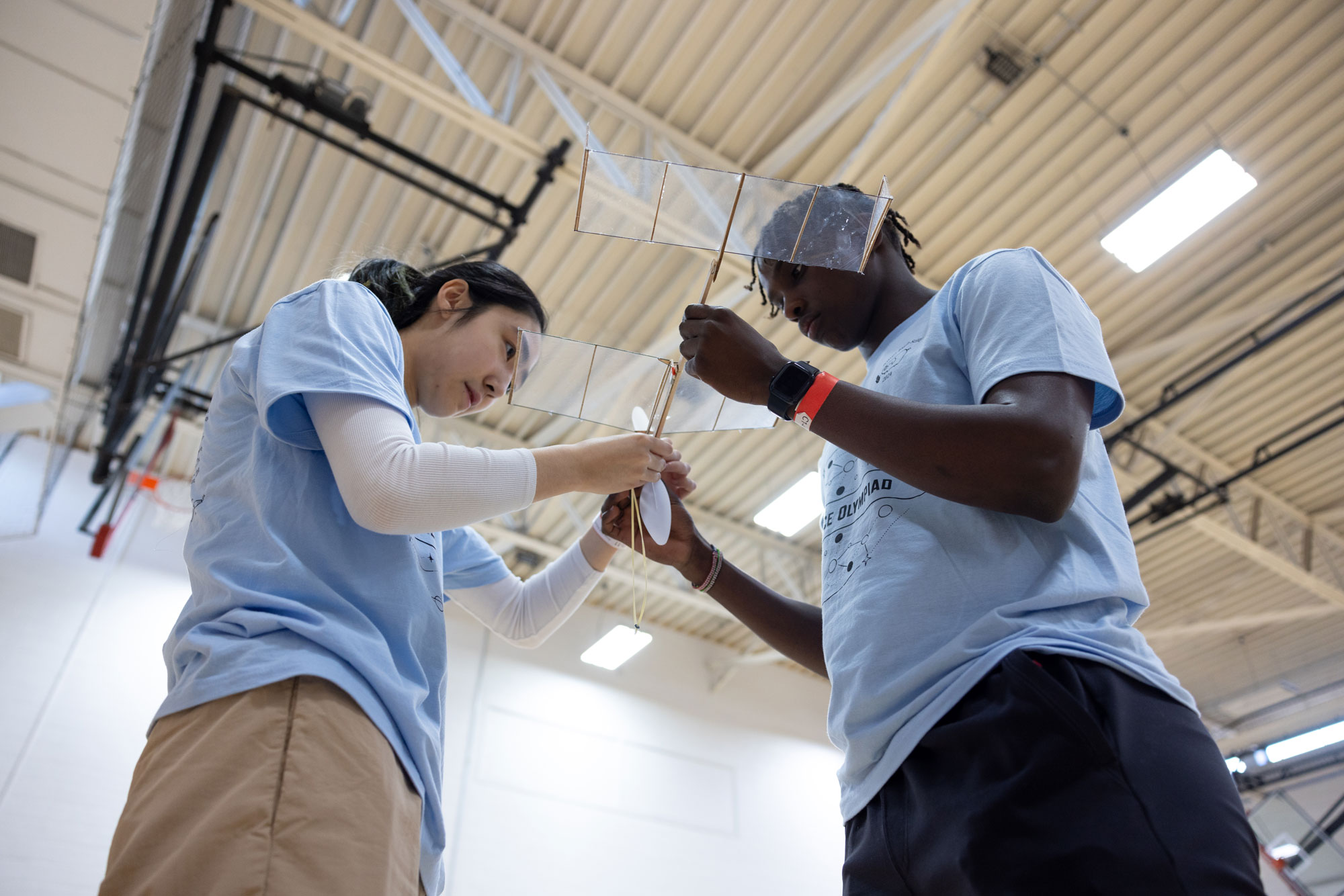 Two students work on small aircraft at Science Olympiad