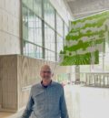 Professor of practice, Michael Anderson in front of the Sukup Atrium ceiling art.