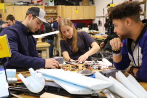 Team working on plane in course lab