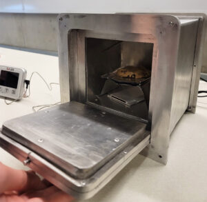 Close-up photo of portable oven with baked cookie inside
