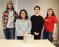 Student team members posing with the portable oven they created