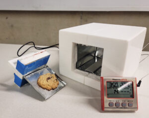 Portable oven with baked cookie and termometer