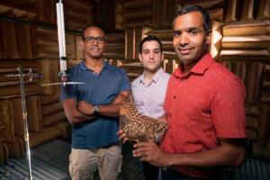 Professor Anupam Sharma with student researchers and owl wing used in 2017 research