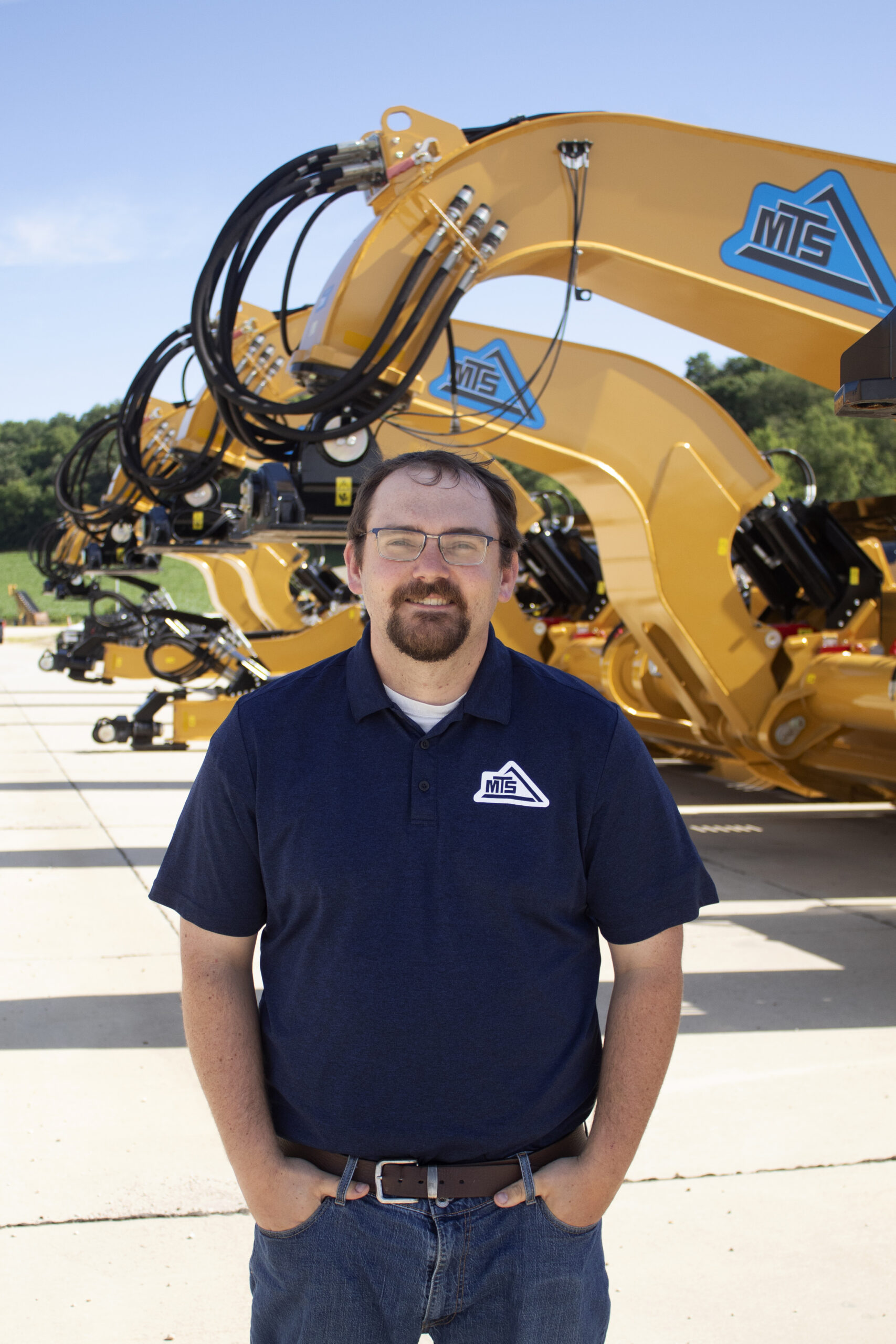 Jacob Bickett standing in front of equipment.