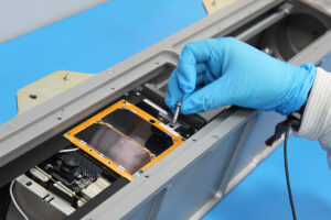 CySAT-1 Cube Sat shown in holder in laboratory during pre-launch inspection