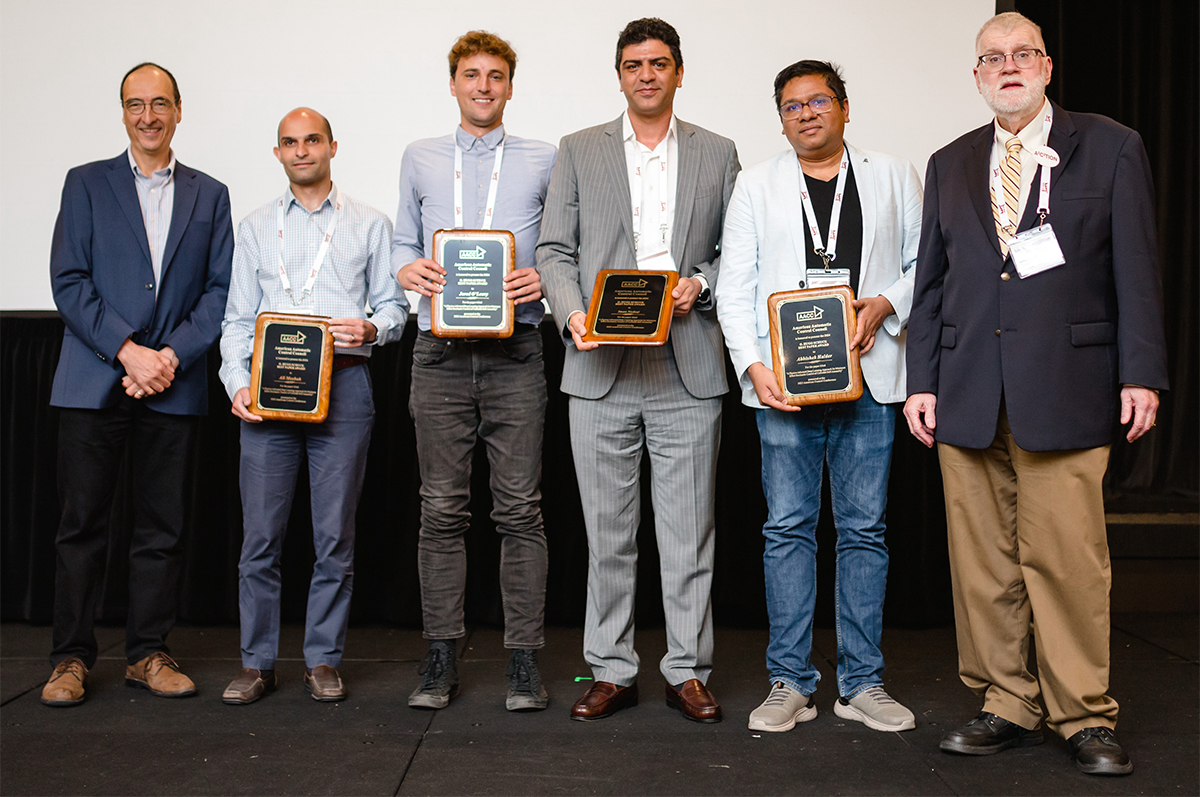 Abhishek Halder posing with fellow research team members and conference officials at