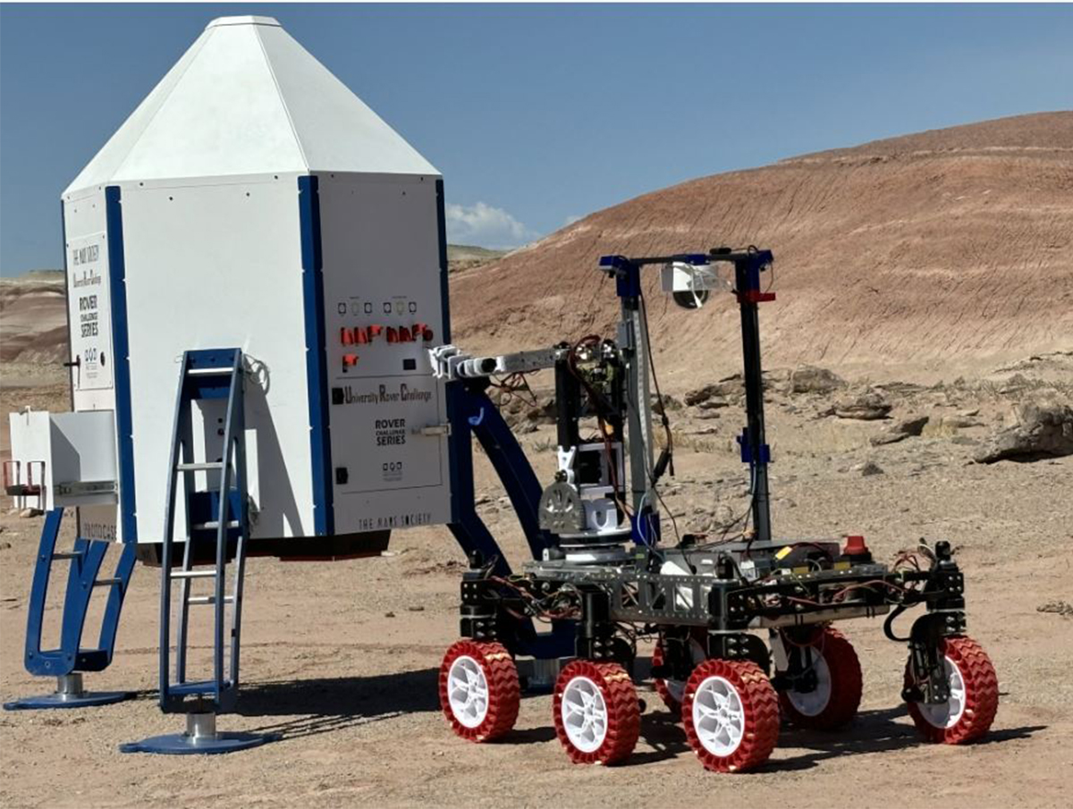 MAVRIC rover shown at Utah competition site completing an operation with a site structure