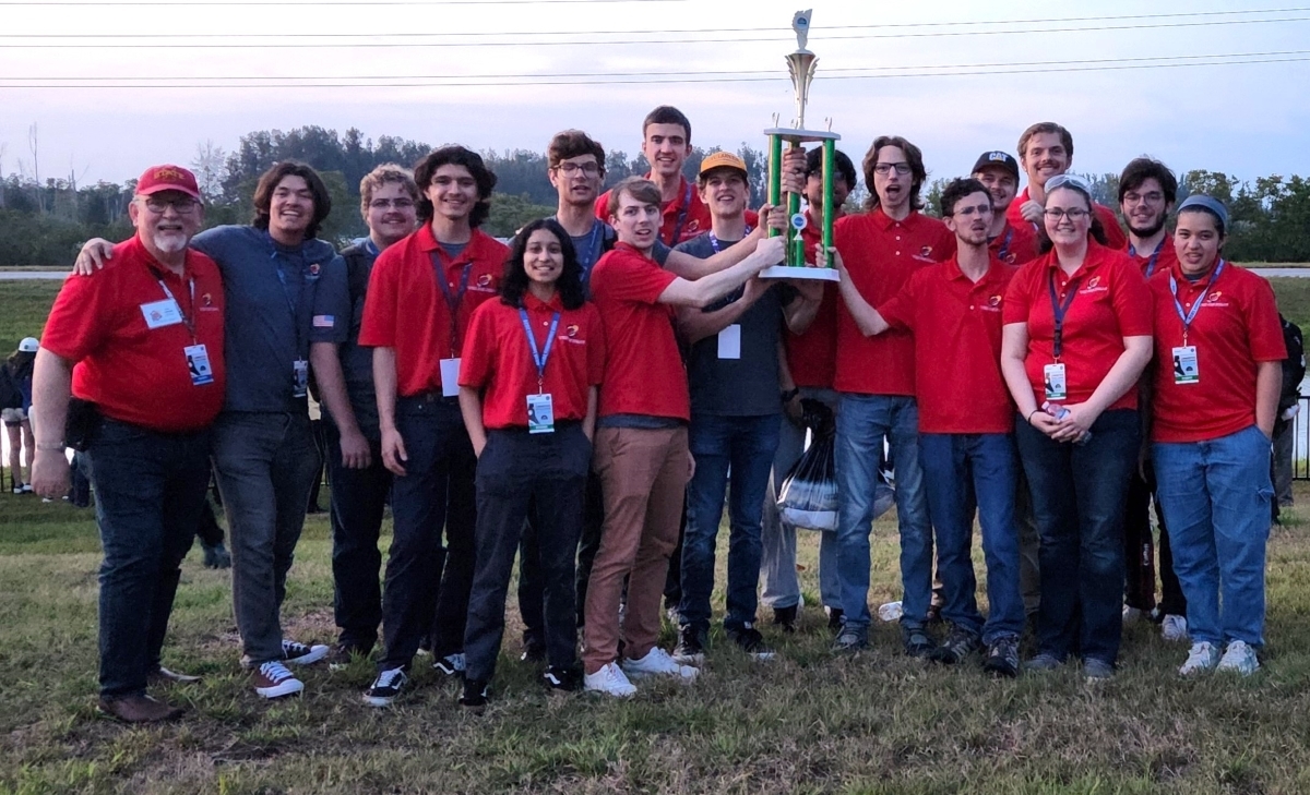 Cardinal Space Mining Team cheers with trophy