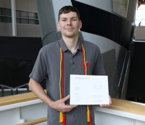 Mason Henry displaying his TEX Award certificate