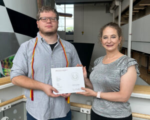 Brian Kempa with his REX Award and major professor Kristin-Yvonne Rozier