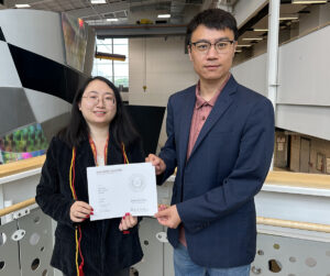 Graduate student Liujing Wang with TEX REX award certificate and major professor Wenjie Xia