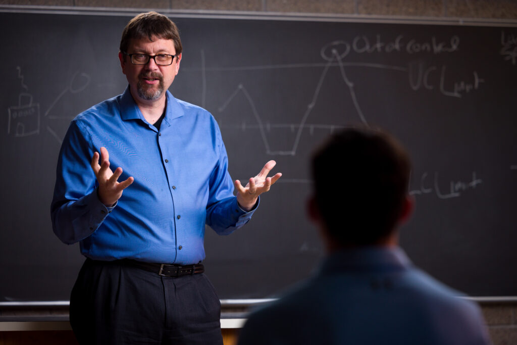 Michael Dorneich, Morrill Professor award recipient, showin in blue shirt teaching student in classroom.