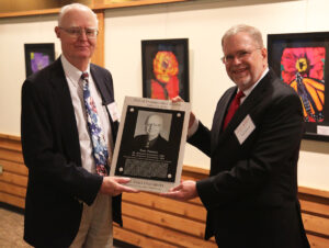 Bion Pierson receiving plaque commemorating induction to Dept. of Aerospace Engineering Hall of Distinguished Alumni in 2016