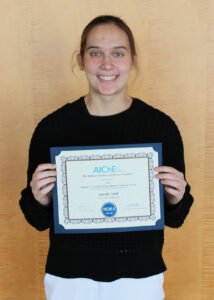 Maria Vitelli holding the Donald F. & Mildred Topp Othmer Scholarship Award certificate