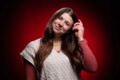 Kara Albrecht, outstanding senior in industrial engineering, poses for a photo in front of a red background.