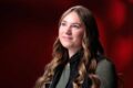 Kennedey Reiling, outstanding senior in electrical engineering, poses for a portrait in front of a red background.