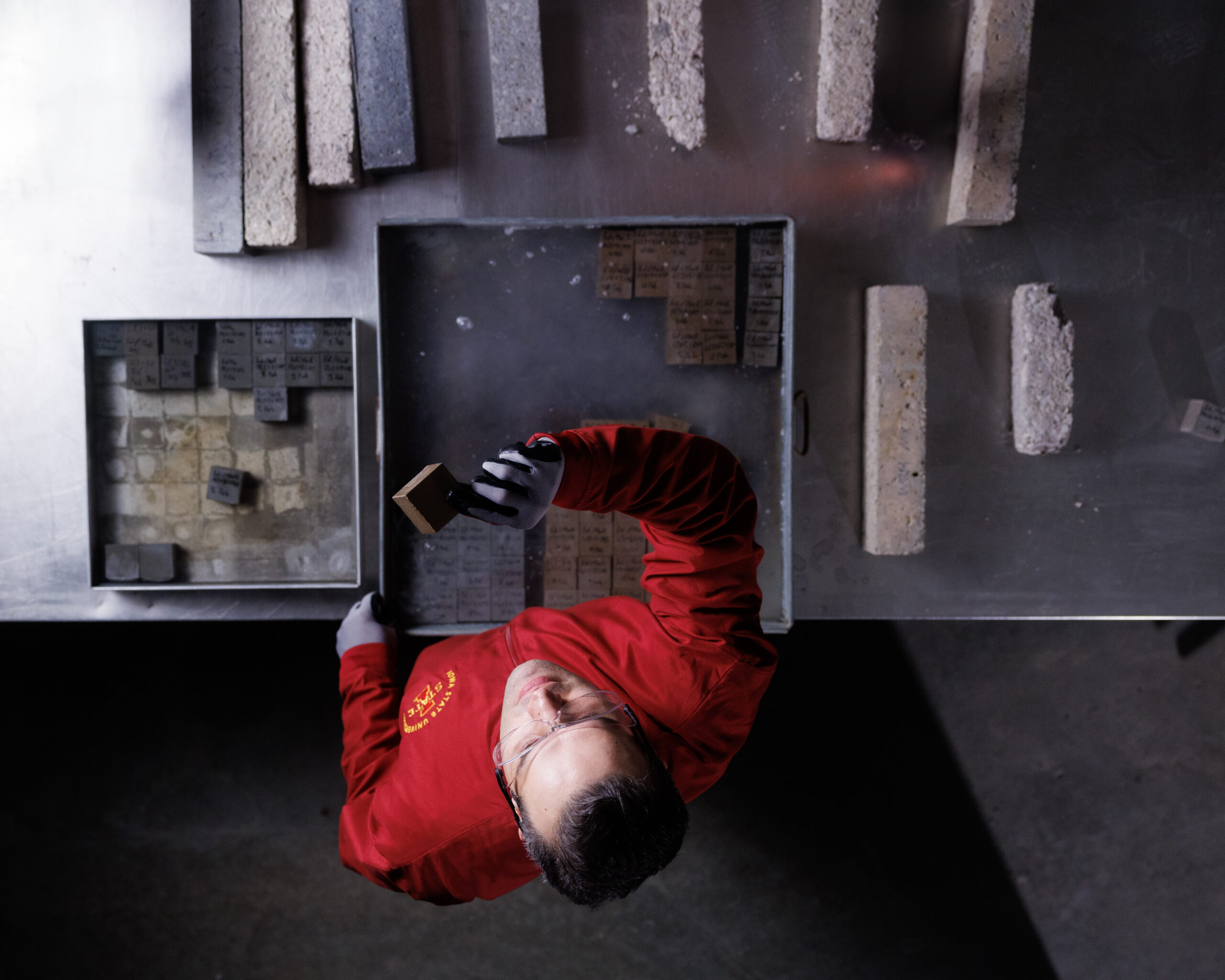 Saeed Nia surrounded by his material samples.