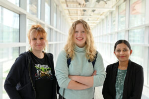 ME student, Sarah Stewart, stands centered between mechanical mentors Paola Pittoni (left) and Aishwarya Pawar (right).