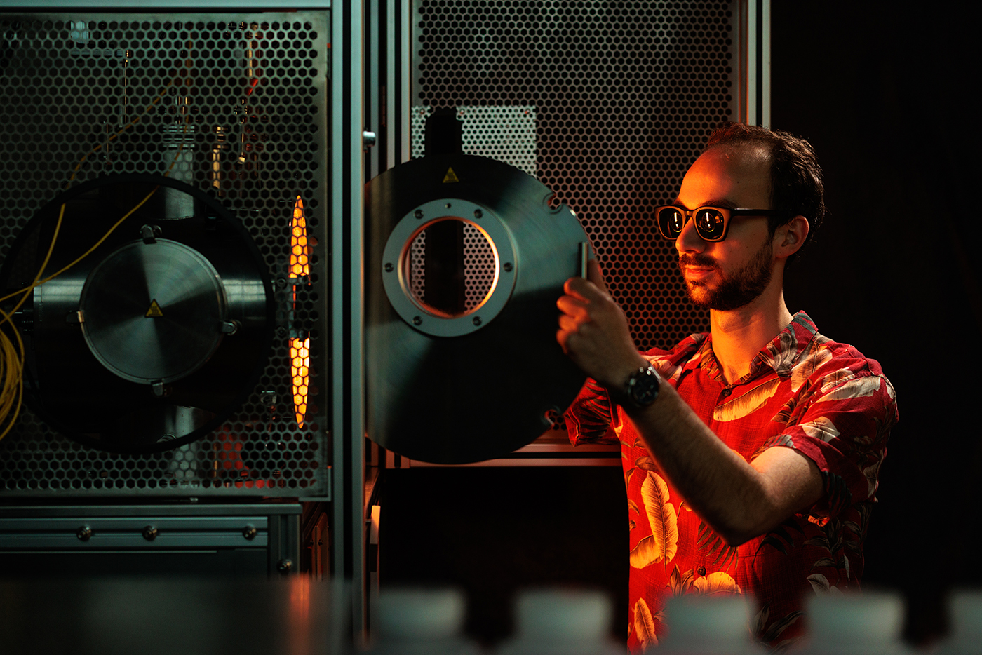 Alexander Goldman working in lab using furnace for metal alloy testing.