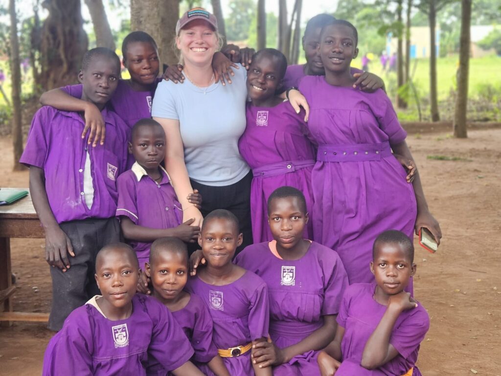 Emma Ostrowski smiles with students.