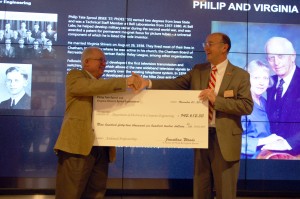 Jonathan Woods presents David C. Jiles with the check.