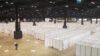 A large facility with white partitions dividing it into individual care spaces.